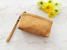 A delightfully elegant and premium gift handmade from natural eco-friendly Cork fabric. This multi-purpose sleek toiletries wash bag is designed in a classic curved half moon shape with a practical zip closure at the top and a zipped pocket on the back. It has a spacious compartment to hold your makeup or toiletry essentials. It is also super light in weight and a convenient size to carry in your handbag. Cork is by nature lightweight, eco-friendly and water resistant. Premium Cork fabric has a luxurious texture, it feels soft and supple like leather but instead it is 100% vegan and harvested from nature.  Material : Cork Fabric Measurements : 8.5 x 12 x 4.5 cm | 23 gms approx Eco-friendly Everyday Rectangular Pouch, Eco-friendly Rectangular Everyday Pouch, Eco-friendly Natural Color Pouch For Everyday, Eco-friendly Rectangular Pouch For Everyday Use, Eco-friendly Travel Bag With Zipper Closure, Eco-friendly Rectangular Cosmetic Bag Gift, Eco-friendly Rectangular Cosmetic Bag For Gift, Eco-friendly Natural Rectangular Pouch, Eco-friendly Pouch Cosmetic Bag For Daily Use