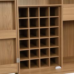 a wooden cabinet with many compartments and shelves