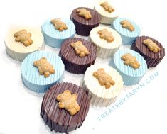 chocolate cupcakes with frosting and cookies in the shape of bears on them