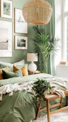 a bedroom with green walls and pictures on the wall