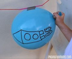 a person holding a blue balloon with the word doo written on it