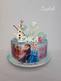 a frozen princess cake with frosting and decorations