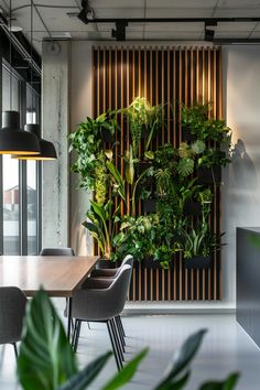 a dining room table with chairs and plants on the wall