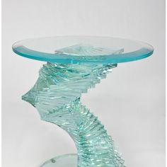 a glass table that has been made to look like a wave on the top and bottom