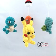 three crocheted stuffed animals hanging from strings