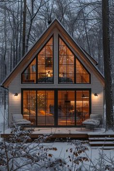 a small cabin in the woods is lit up at night with lights on it's windows