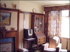 a living room filled with furniture and a flat screen tv on top of a wooden stand