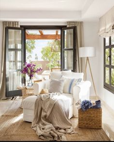 a living room filled with furniture and lots of windows