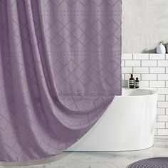 a bath room with a toilet and a purple shower curtain in front of a white tiled wall