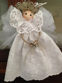 an angel doll with white dress and wings