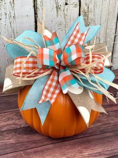 an orange pumpkin with a bow on it