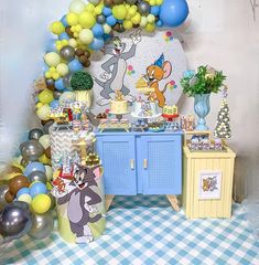 a birthday party with decorations and balloons on the wall, including winnie the pooh table