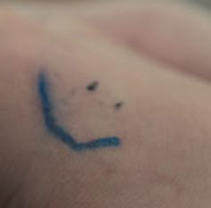 a close up of a person's arm with a blue marker on the side