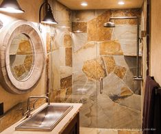 a bathroom with a sink, mirror and shower stall is shown in this image from the inside