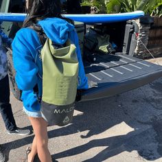 a person with a surfboard in their back pack