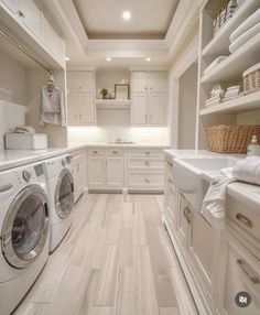 a white laundry room with washer and dryer