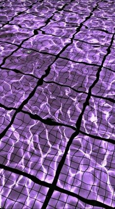 an image of water that is reflecting on the ground with purple lights and reflections in it