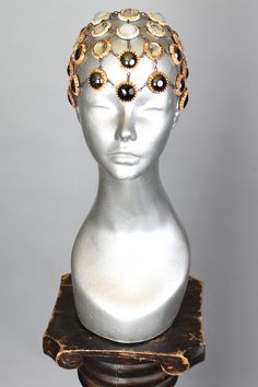 This is a one of a kind piece of wearable art made for the Five and Diamond Seventh Annual Headgear Art Show and shown on August 2, 2019. Intentional adornment - fits heads from 21”- 24” Designed by FoolProof Studio One of a kind Unisex MATERIALS USEDGlass and metal. WEARING INSTRUCTIONSThere’s slight difference with the front and the back side of the design. Front side worn with the black jewel at center of forehead (it’s is surrounded by smooth hematite cabochons). The back side, as a “layer” Unique Handmade Crown Headpiece, Elegant Handmade Ceremonial Headpieces, Elegant Ceremonial Handmade Headpieces, Handmade Elegant Festival Headpiece, Elegant Handmade Festival Headpiece, Handmade Adjustable Headpieces For Evening, Handmade Adjustable Evening Headpieces, Luxury Crown-shaped Jewelry For Parties, Luxury Crown Shaped Jewelry For Parties