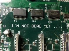 an electronic board with some microchips on it that says i'm not dead yet