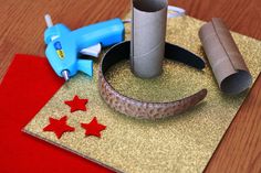 some crafting supplies sitting on top of a piece of gold glitter paper with red stars