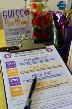 a menu sitting on top of a clipboard next to a cup filled with candy