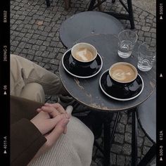 two cups of coffee are sitting on a table