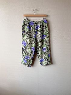 ~* ALL ITEMS ARE UNIQUE VINTAGE PIECES *~ ITEM DESCRIPTION: These y2k era capri pants feature a fabulous multicolor mixed print of tropical floral and leopard. Perfect for the spring/summer season. Material is 100% Silk, and it zips up on the left side. Please note that the seam on the right side of the pants (while being worn) is slightly loosened where the threads can be seen, but there is actual no hole. (Check last photo) Other than the noted flaw the garment is still in great condition.  SIZE: Medium  MEASUREMENTS: (All measurements are taken while the garment is laying flat. Please note that vintage sizing is not always the same as modern day sizing and the exact measurements will ensure the best fit. Waist and Hips measurements are already doubled.)  Waist: 28 in. Hips: 41 in. Rise: Vintage Floral Print Summer Pants, Vintage Spring Loungewear Pants, Vintage Loungewear Pants For Spring, Spring Vintage Loungewear Pants, Vintage Multicolor Spring Pants, Vintage Multicolor Bottoms For Spring, Vintage Long Pants For Summer, 90s Style Multicolor Spring Bottoms, Vintage Multicolor Summer Pants