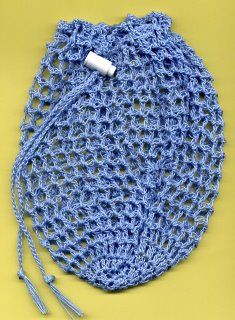 a blue crocheted bag sitting on top of a yellow table