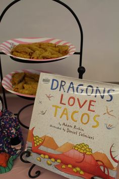 there is a book titled dragon's love tacos next to other food items