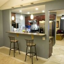 two bar stools sit in front of the kitchen counter