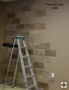 a ladder sitting on top of a floor in front of a wall covered in bricks