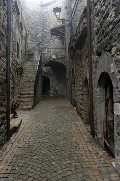 an alley way with stone buildings and stairs