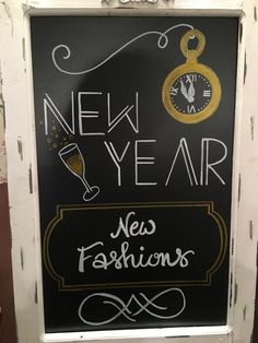 a new year's eve fashions sign with a clock on it and the words new year written in chalk