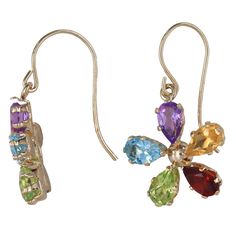 Each petal showcases a different color, featuring Spinel, Citrine, Tourmaline, Aquamarine, and Garnet gemstones. Crafted with exquisite detail and set in radiant yellow gold, these earrings are a vibrant and elegant addition to any ensembleMaterial: 14K Yellow GoldWeight: 1.3gLength: 21.7 mmDiameter: 13 mmSpinel, Citrine, Tourmaline, Aquamarine, Garnet: 0.14Ctw (Each)Total Carat Weight: 0.7CtwFor more of our jewelry products, please visit our shop 777jewelryLAFree shipping on all orders within U Elegant Multicolor Flower-shaped Earrings, Elegant Multicolor Flower Earrings, Real Gold Jewelry, Sell Gold, Garnet Gemstone, Gold Filled Jewelry, Real Gold, Aquamarine, Flower Designs