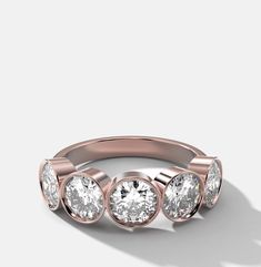 a rose gold ring with three diamonds on it