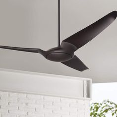 a black ceiling fan in a white room