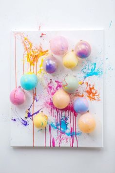 an art work with paint and balloons on it