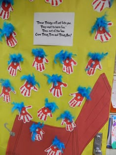 a bulletin board with blue and red handprints on it