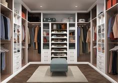 a walk in closet filled with lots of white drawers and shelves next to a blue chair