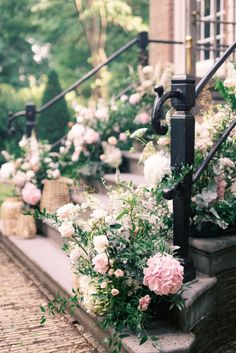 some flowers are growing on the steps outside