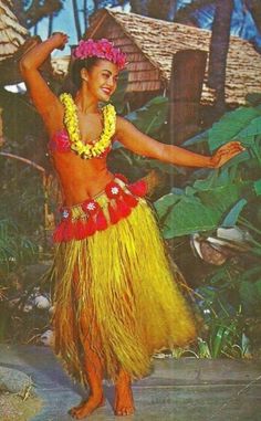 a woman in a yellow hula skirt dancing