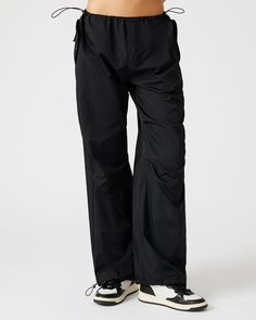 A wide leg casual pant is essential for an updated silhouette and the adjustable PIA parachute pants use stretch cord drawstrings and clever tailoring to maximize the voluminous silhouette. Wide parachute pants Zipper fly closure Two side snap pockets Stretch cord drawstring with toggle closure in waistband and cuffs Length: 30.25" 55% nylon 45% polyester Care instructions: hand wash cold separately, do not bleach, lay flat to dry, low iron if necessary, or dry clean Shop the set here Jelixza is Techwear Style Wide Leg Parachute Pants With Cargo Pockets, Techwear Wide Leg Cargo Parachute Pants, Nylon Techwear Pants With Functional Drawstring, Solid Wide-leg Techwear Parachute Pants, Wide-leg Parachute Pants With Drawstring For Streetwear, Nylon Techwear Parachute Pants With Functional Drawstring, Functional Wide Leg Parachute Pants For Outdoor, Functional Wide-leg Parachute Pants For Outdoor, Techwear Wide Leg Parachute Pants With Side Pockets