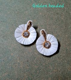 "Floral white and gold raffia bridal stud earrings. These raffia flower studs are very lightweight, beautiful and elegant. Earrings are desirable to those who would love to wear small and light weight earrings for a bohemian theme weddings.  These earrings can also be worn or paired up with other formals dresses and tops. Available in two options: Golden beaded stud Golden painted stud Earrings measure: Approx. Length 2\" width is 1.75\". At Carnation jewellery, each piece is artisan handcrafted in India with love and care. Each pair of earrings are unique and one of a kind. There may be a slight imperfection due to the nature of work. The color and appearance may not match the picture exactly but I try to make them as perfect as it can be. * SHIPPING - Please refer to the \"announcement\" Elegant White Flower Earrings For Celebration, White Flower Earrings For Celebration, Handmade White Flower Earrings For Formal Occasions, White Handmade Flower Earrings For Anniversary, White Beaded Round Earrings For Party, White Round Flower Earrings For Wedding, Handmade White Flower Earrings For Anniversary, Handmade White Earrings For Anniversary, White Flower Earrings For Wedding