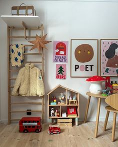 a child's room with toys, bookshelves and posters on the wall