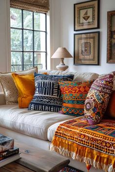 a living room filled with lots of colorful pillows