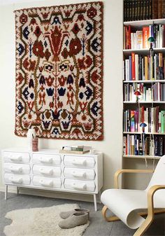 a living room filled with furniture and bookshelves next to a wall covered in bookcases