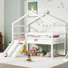 a child's bedroom with a white bunk bed and play house on the floor