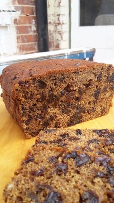 a loaf of banana bread sitting on top of a wooden table next to a knife