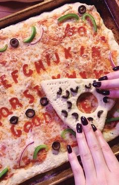 two hands reaching for a slice of pizza with the word pizza written on it and olives