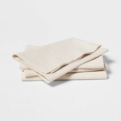 three linen napkins stacked on top of each other